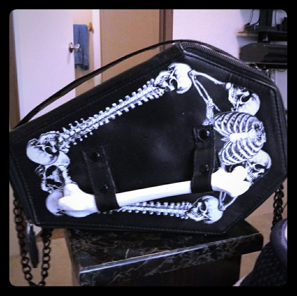 Black leather coffin purse.